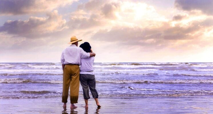 a couple standing looking at galveston beach